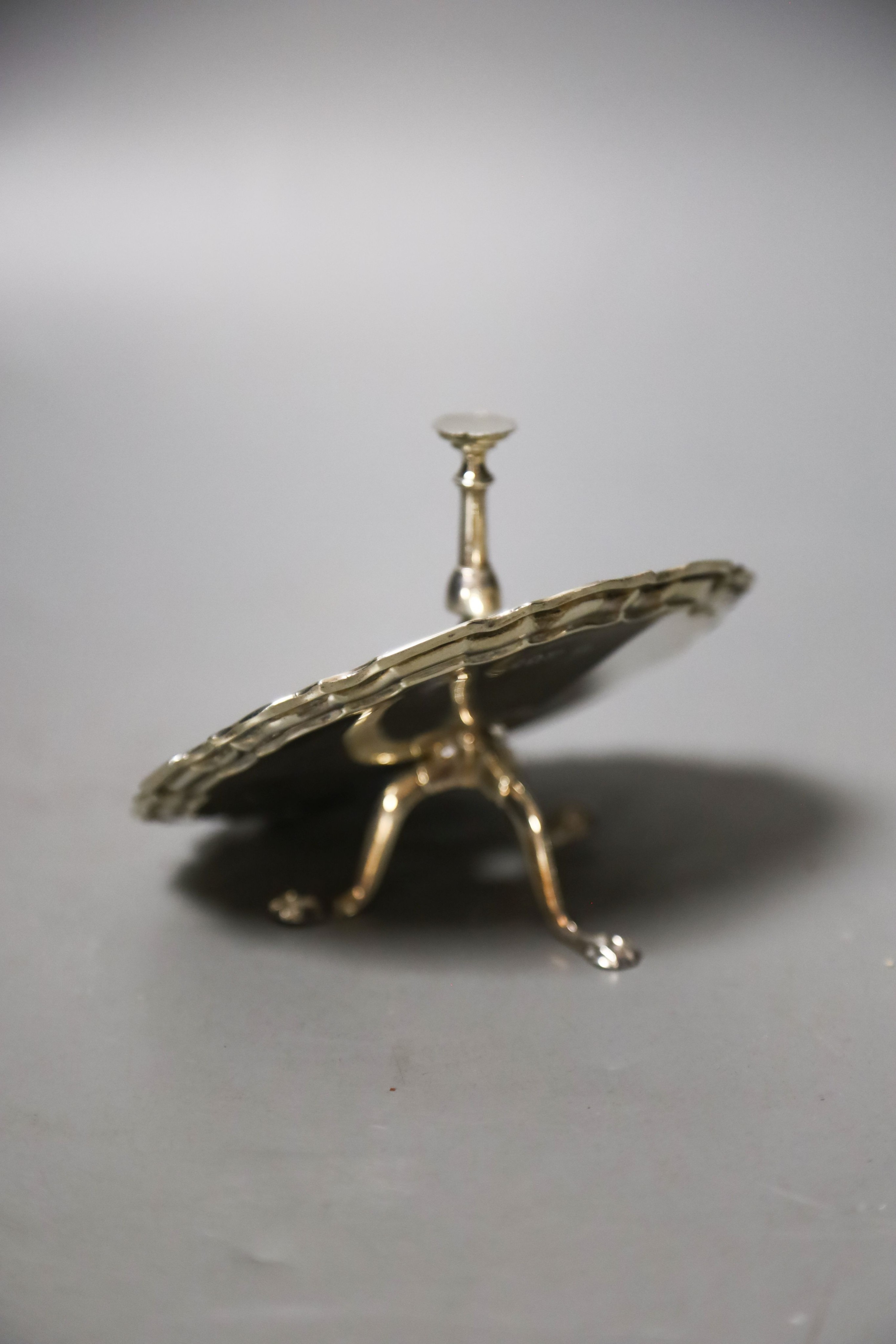 A George V silver miniature model of an occasional table(a.f.), Goldsmiths & Silversmiths Co Ltd, London, 1910, height 9.6cm, 91 grams.